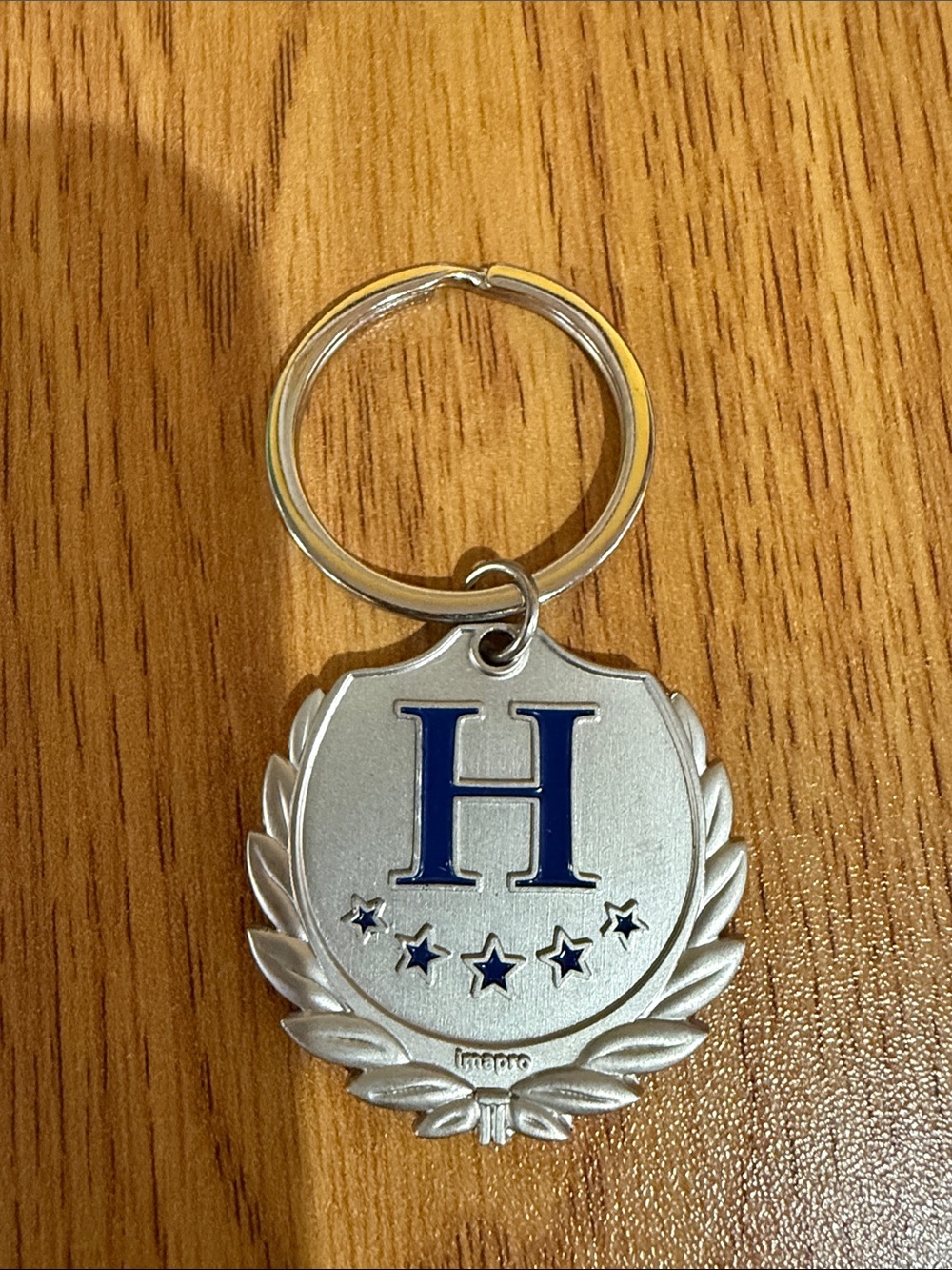 Silver Metal Keychain with Blue 'H' Crest